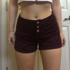 High waisted maroon shorts.
